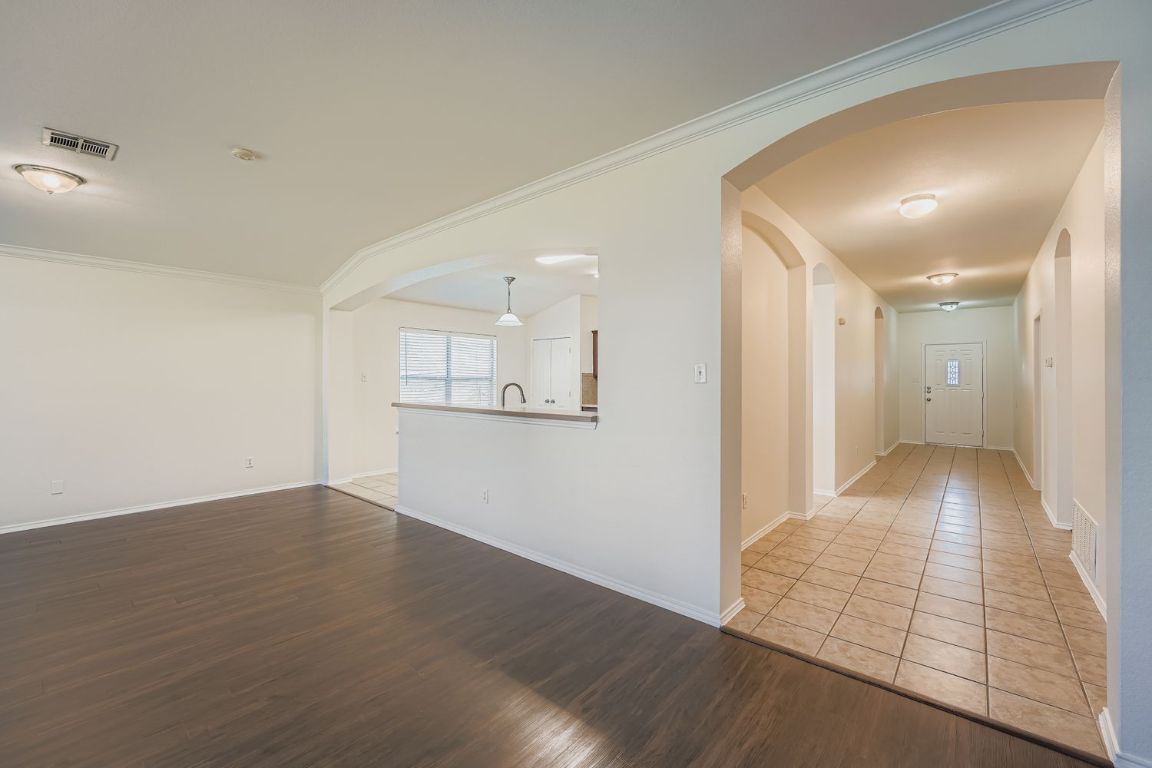 12612 Waynespur Lane Elgin, TX 78621 - Photo 3 of 22 a view of a hallway with wooden floor