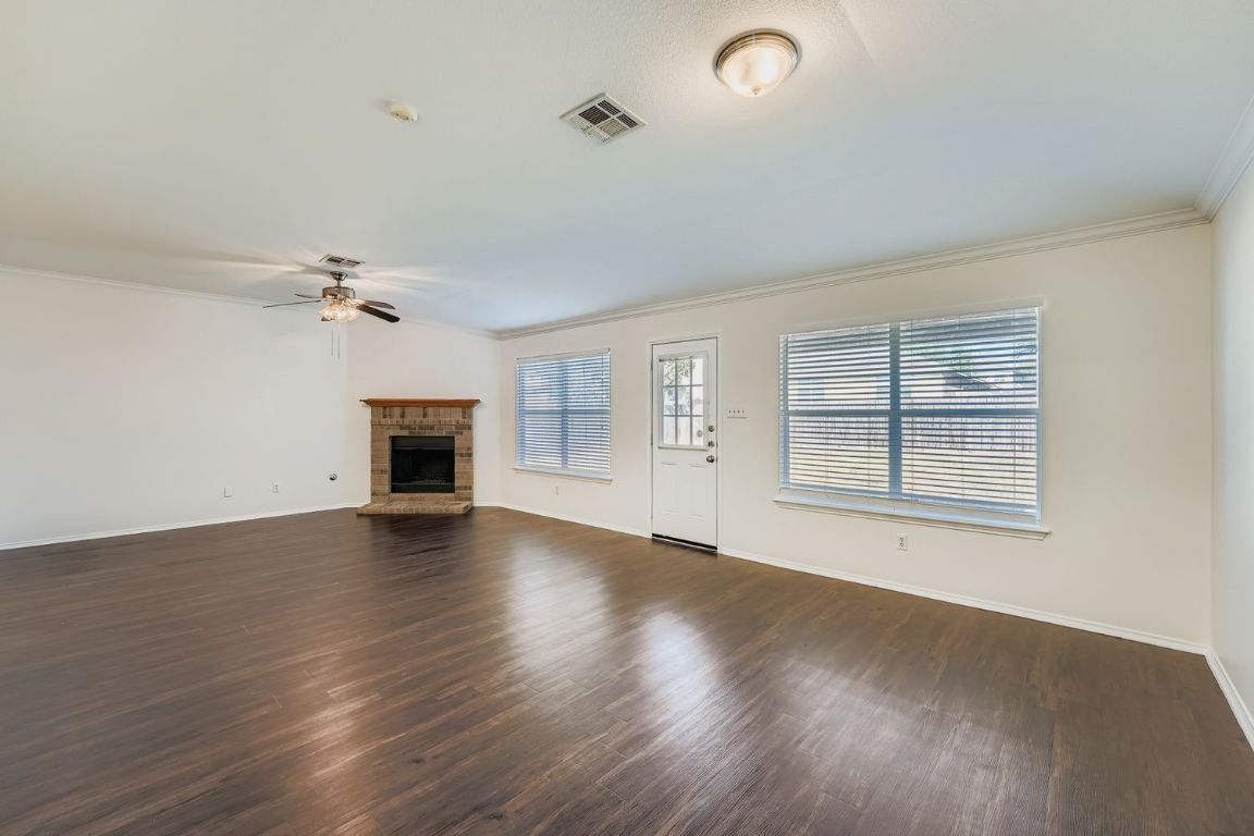 12612 Waynespur Lane Elgin, TX 78621 - Photo 5 of 22 wooden floor in an empty room with a window