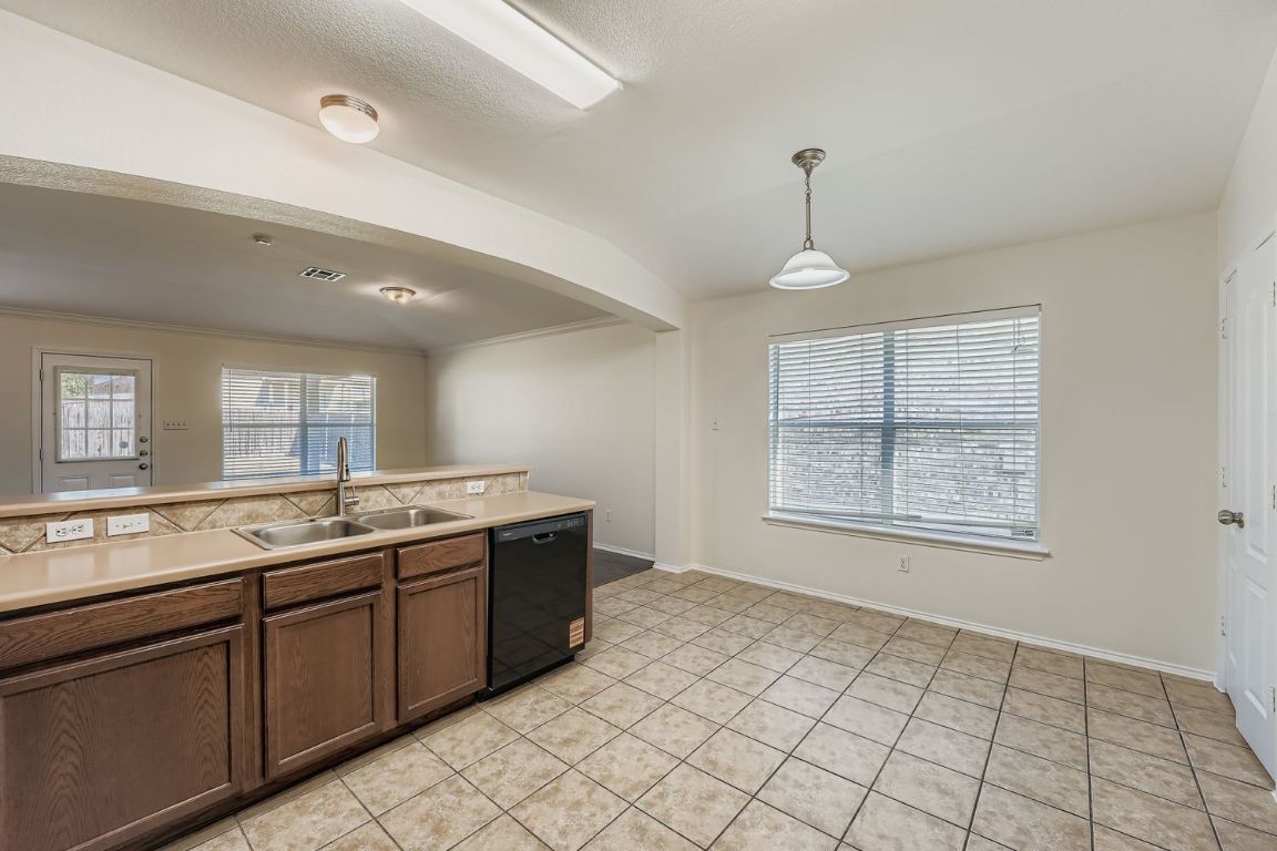 12612 Waynespur Lane Elgin, TX 78621 - Photo 8 of 22 a view of a kitchen with a sink and window