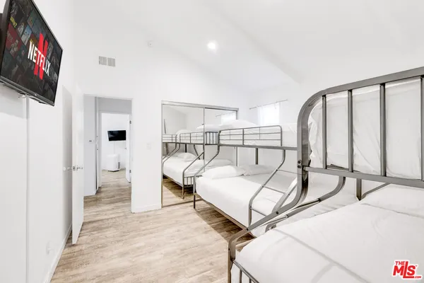 a bedroom with a bed and a flat screen tv