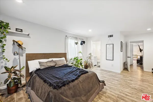 a bedroom with furniture and a flat screen tv
