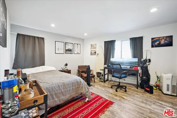 a bedroom with furniture a bed and a couch