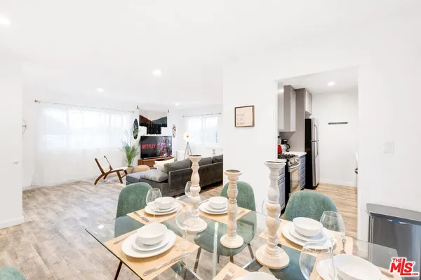 a living room with dining table and wooden floor