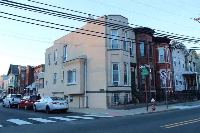 a view of a street that has couple of cars parked on the road