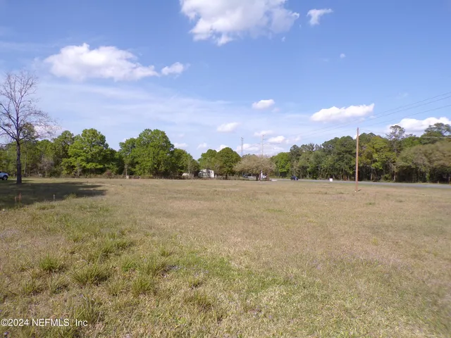 a view of lake with green field