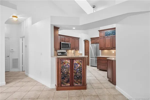 a kitchen with stainless steel appliances a refrigerator and a stove top oven