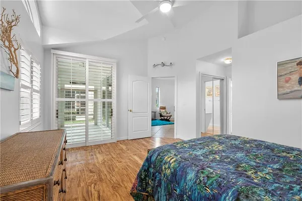 a bedroom with a bed and glass windows
