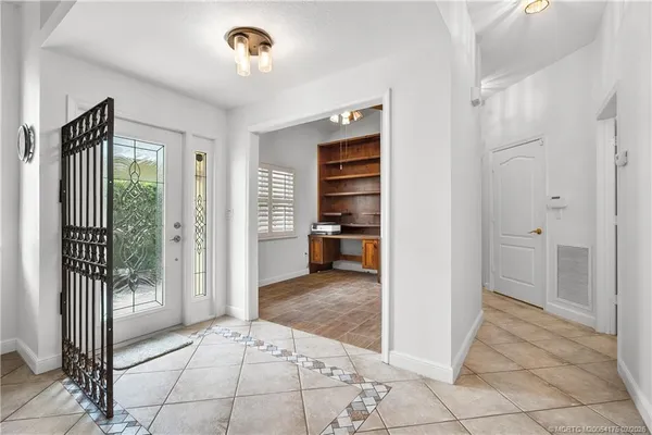 a view of a hallway to a room with a livingroom