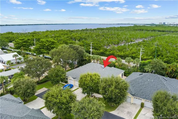 a backyard of a house with lots of green space and mountain view in the background