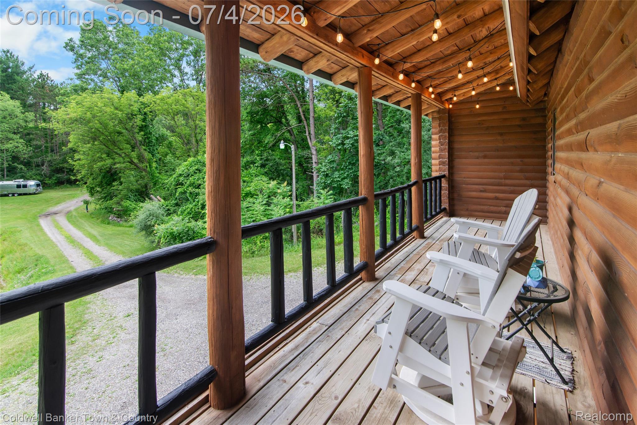 7335 Richardson Road Howell, MI 48843 - Photo 10 of 54 Covered porch featuring a natural wood-finish ceiling, exposed log beams, and string lighting