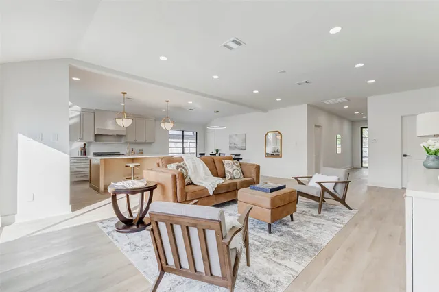 a living room with furniture a window and a table