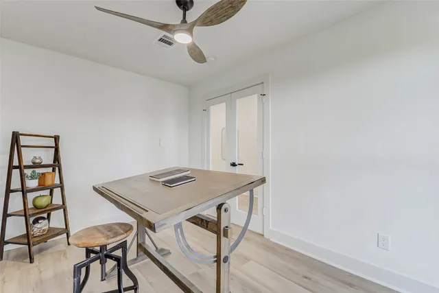 a view of a workspace with furniture and wooden floor