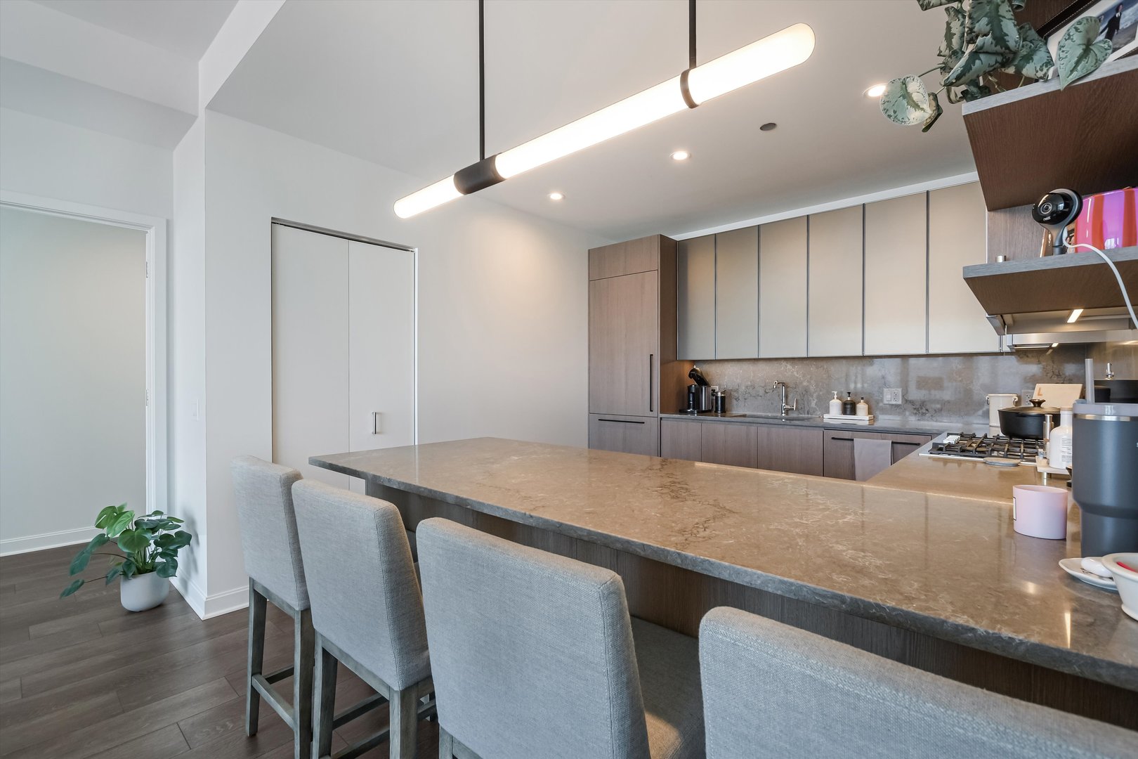 164 North Peoria Street, Unit 4004 Chicago, IL 60607 - Photo 12 of 32 a large kitchen with granite countertop a stove a sink a dining table and chairs