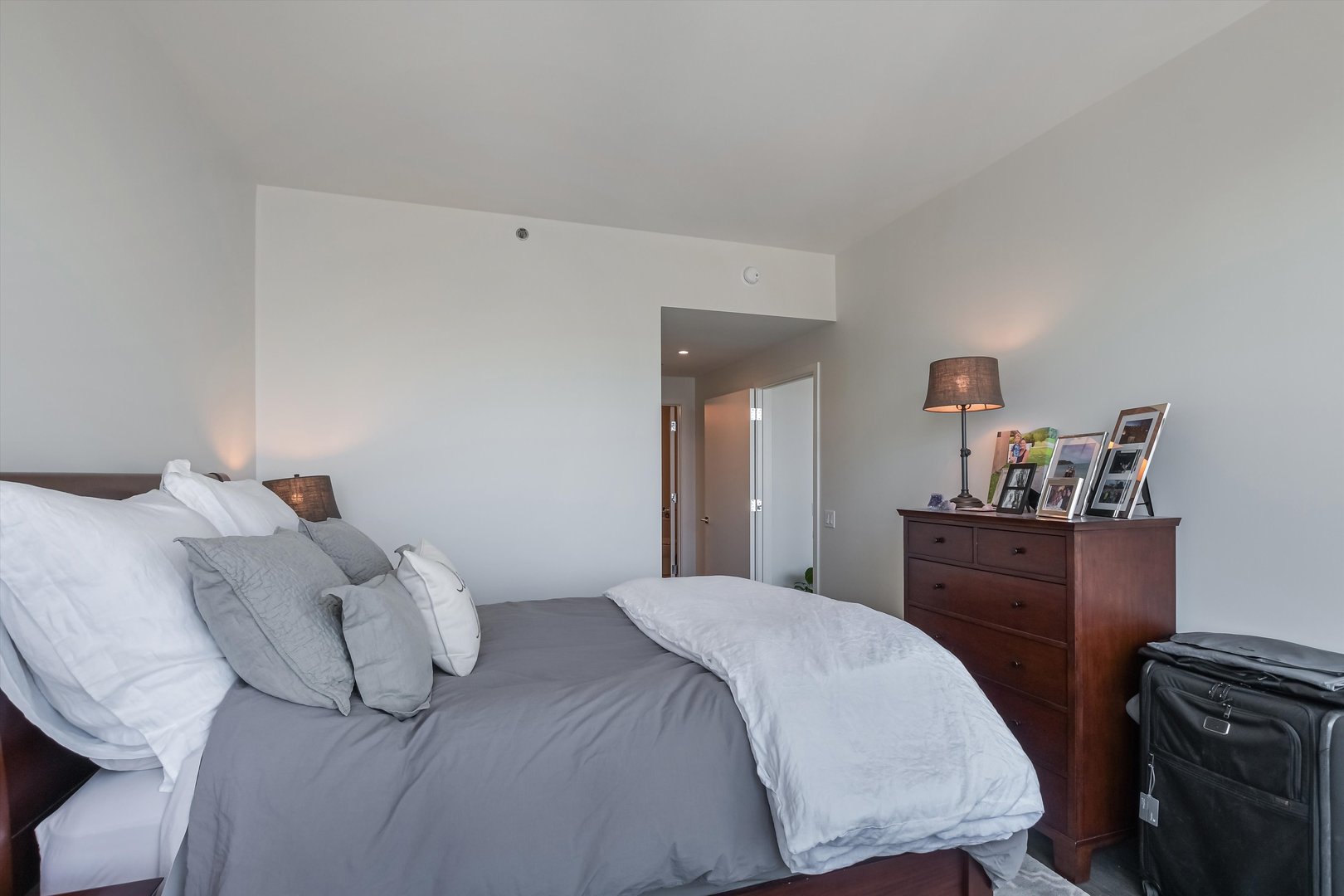 164 North Peoria Street, Unit 4004 Chicago, IL 60607 - Photo 14 of 32 a bedroom with a bed and wooden floor