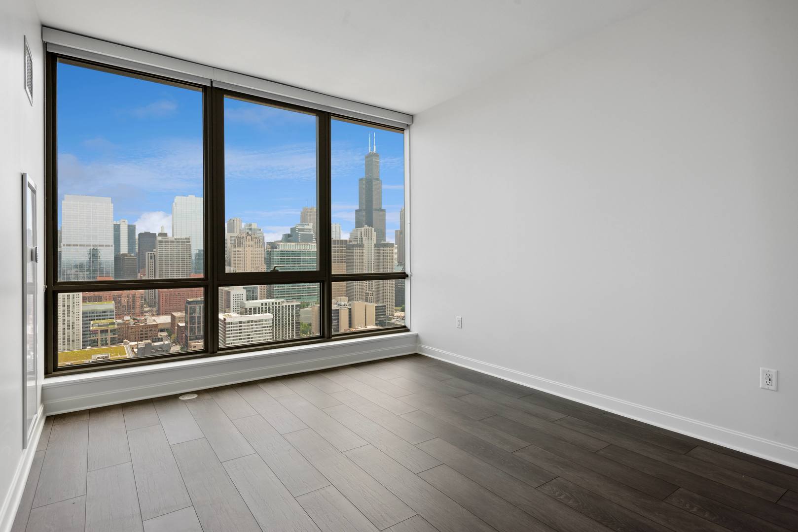 164 North Peoria Street, Unit 4004 Chicago, IL 60607 - Photo 31 of 32 wooden floor in an empty room with a window