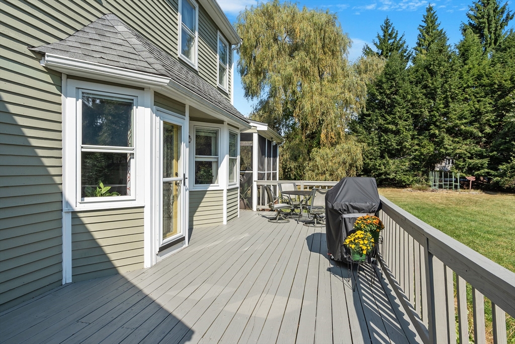 583 Great Road Stow, MA 01775 - Photo 36 of 41 a view of a deck with wooden floor and seating space