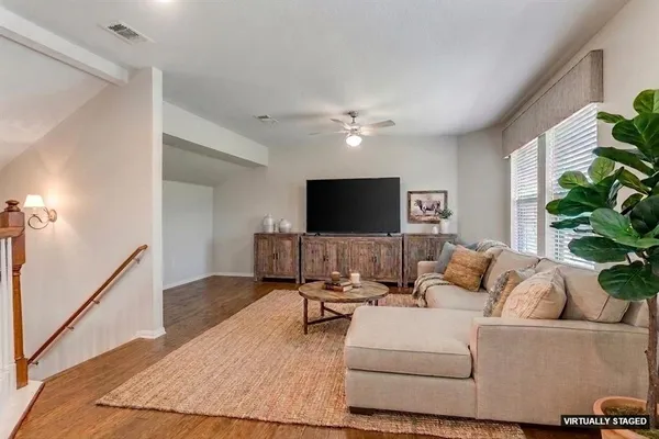 a living room with furniture and a flat screen tv