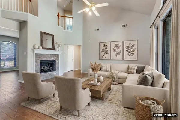 a living room with furniture a fireplace and a flat screen tv