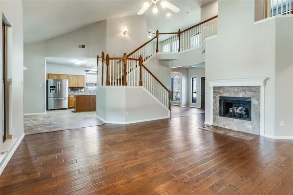 a view of a livingroom with wooden floor and a fireplace