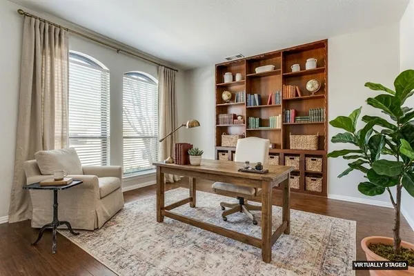 a view of a livingroom with workspace and a window