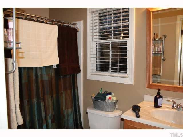 The master bath features maple cabinets with mirror and tile flooring. Master Bath/Spa