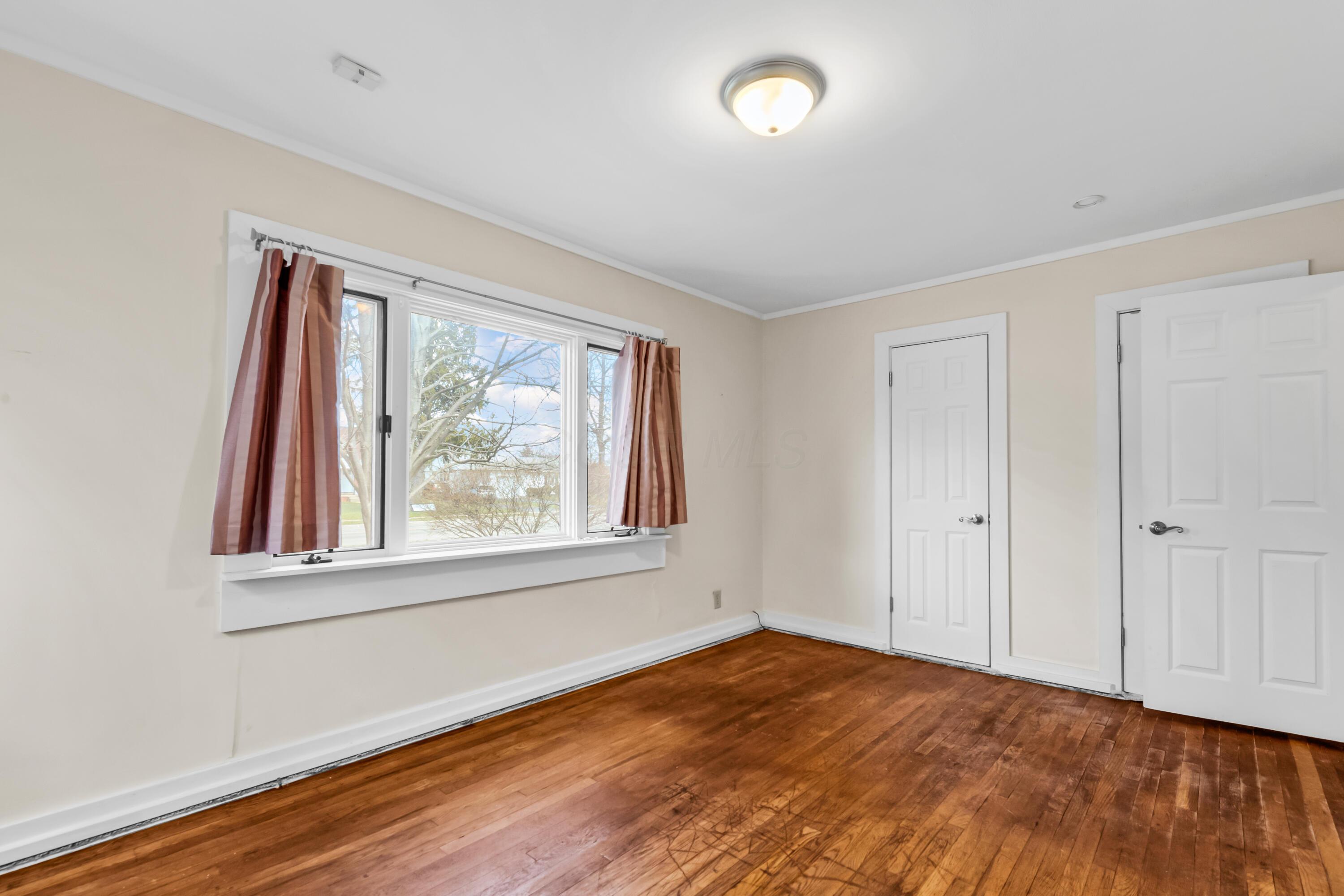 2033 Zollinger Road Columbus, OH 43221 - Photo 19 of 44 • Hardwood flooring
• Ivory painted walls
• Ceiling light
• (2) single door closets