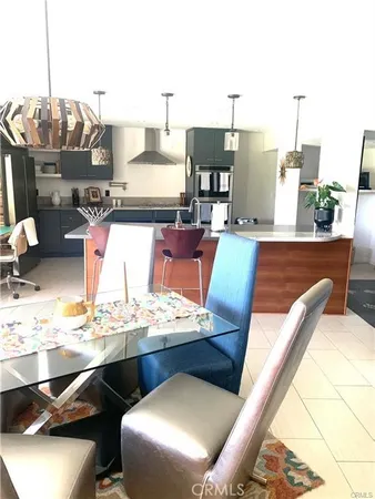a kitchen with a sink a stove and chairs