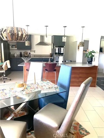 a kitchen with a sink a stove and chairs