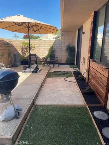 a view of a porch with a table and chairs
