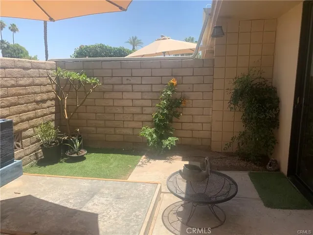 a view of a hallway with wooden floor and closet area
