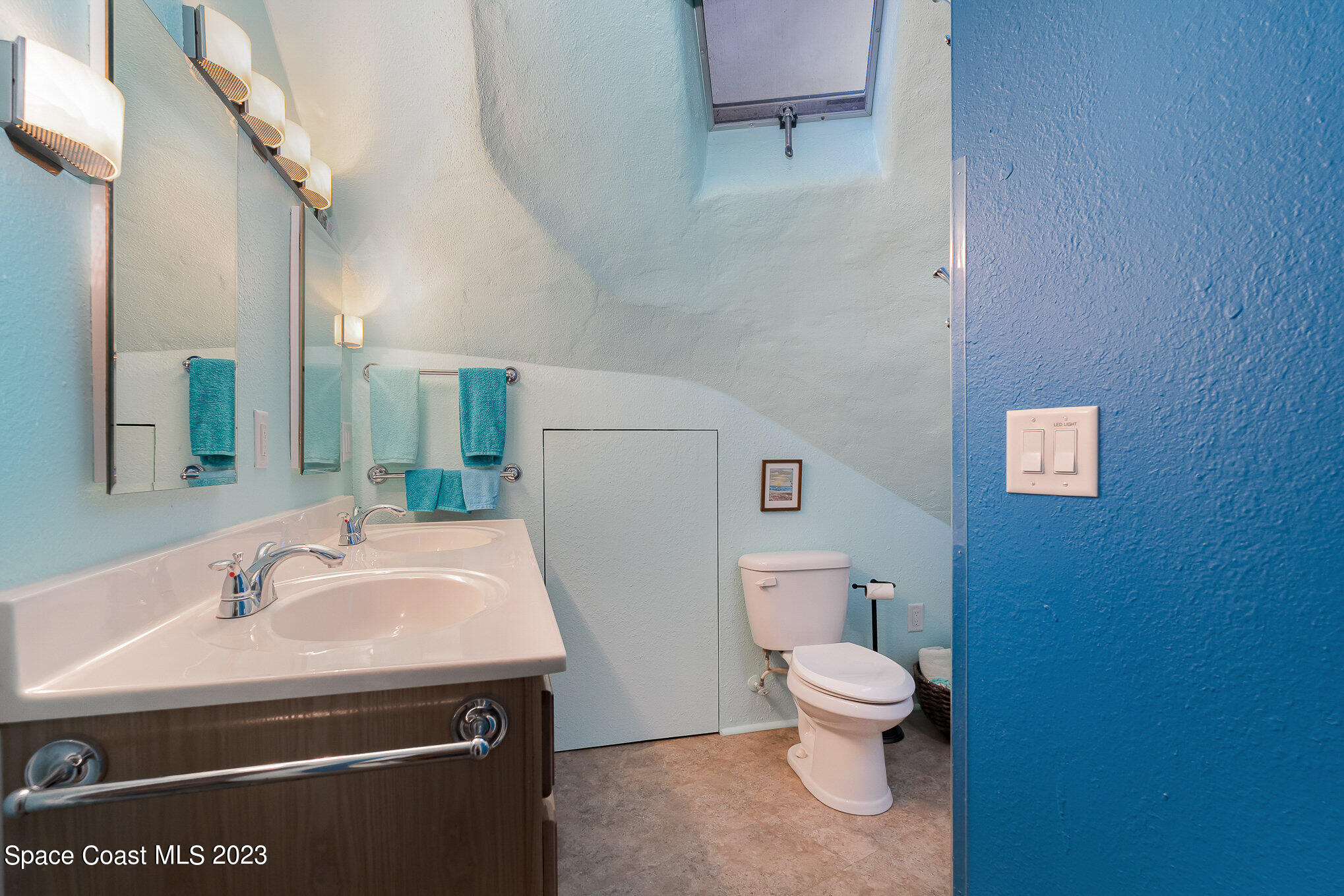 2025 Cox Road Cocoa, FL 32926 - Photo 23 of 49 a bathroom with a sink a toilet and a mirror