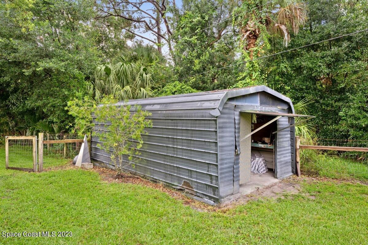 2025 Cox Road Cocoa, FL 32926 - Photo 33 of 49 a view of a wooden house with a yard