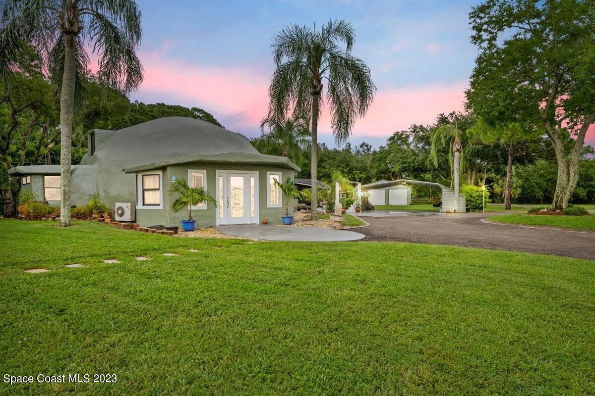 2025 Cox Road Cocoa, FL 32926 - Photo 47 of 49 a swimming pool with outdoor seating and yard