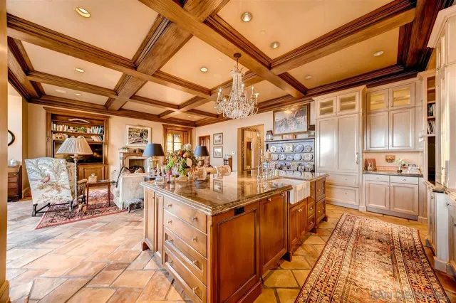 a living room with lots of furniture and a refrigerator