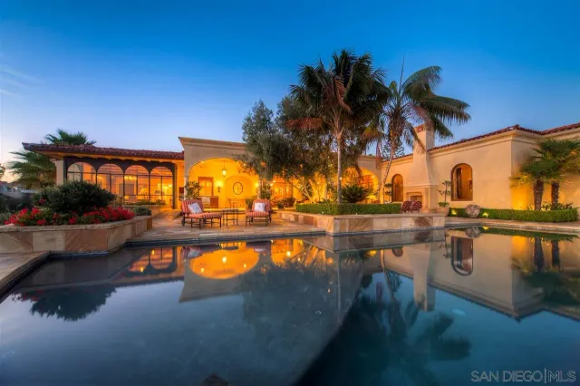 a view of swimming pool with outdoor seating and lake view