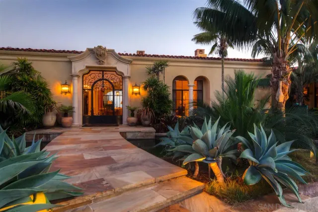 a front view of a house with a yard and a garage