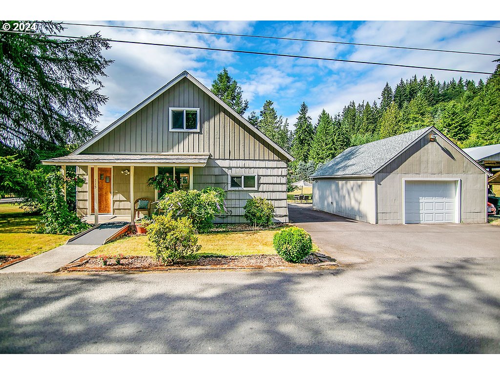 115 Stewart Creek Road Longview, WA 98632 - Photo 1 of 31 a front view of a house with a yard and potted plants