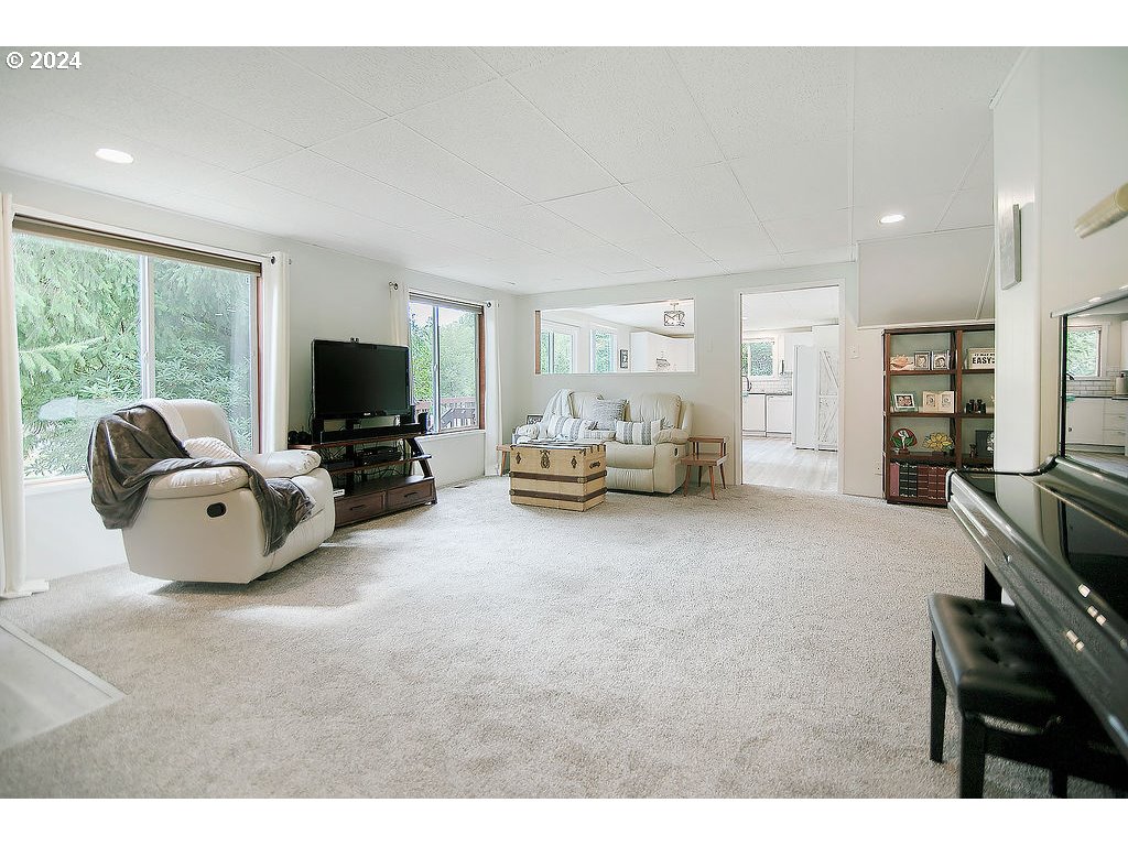 115 Stewart Creek Road Longview, WA 98632 - Photo 2 of 31 a living room with furniture a flat screen tv and a fireplace