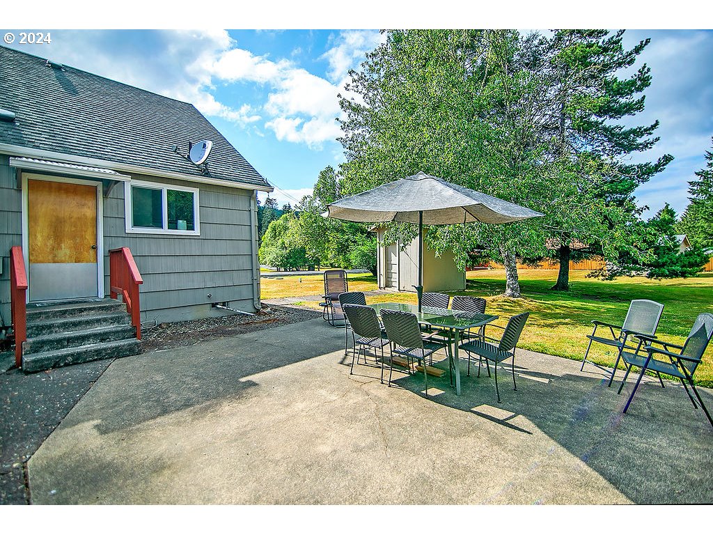 115 Stewart Creek Road Longview, WA 98632 - Photo 28 of 31 a view of a house with backyard sitting area and garden