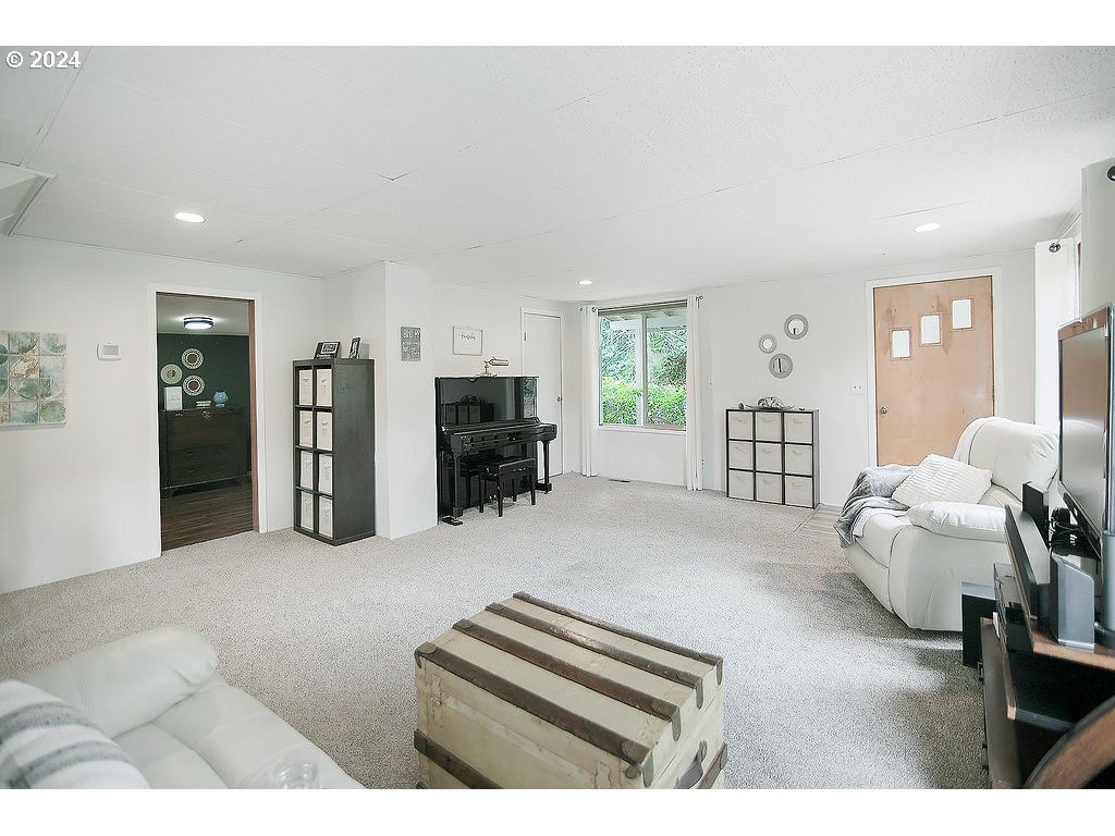 115 Stewart Creek Road Longview, WA 98632 - Photo 3 of 31 a living room with furniture and a flat screen tv
