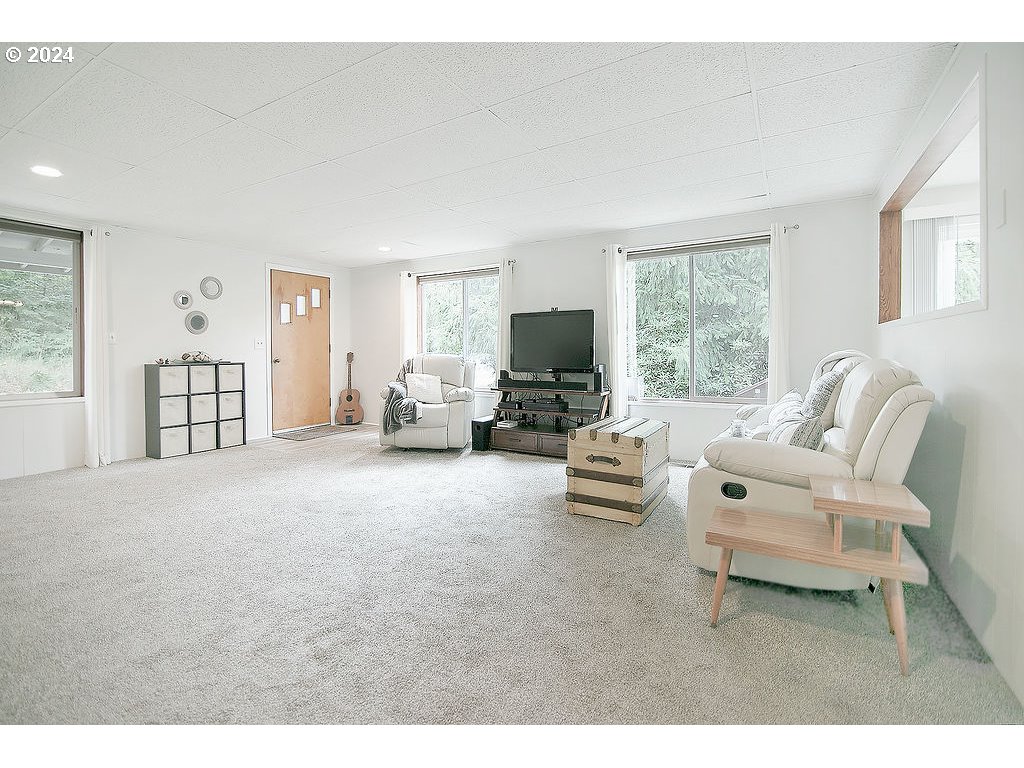 115 Stewart Creek Road Longview, WA 98632 - Photo 5 of 31 a living room with furniture and a flat screen tv