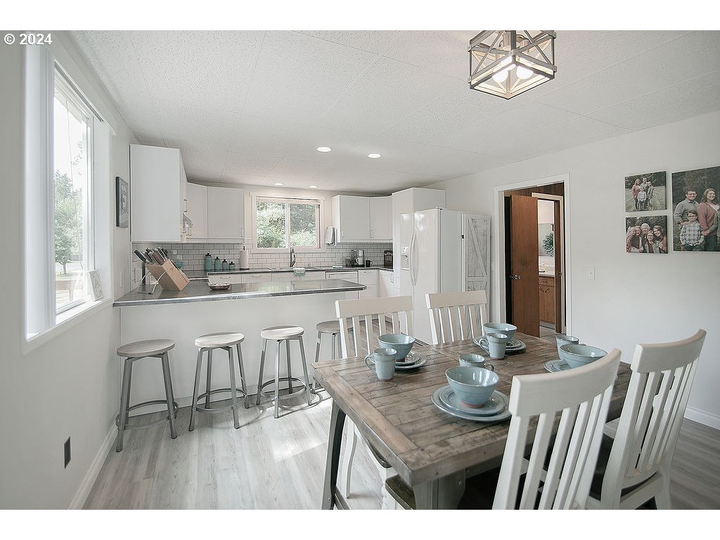 115 Stewart Creek Road Longview, WA 98632 - Photo 7 of 31 a dining room with furniture and wooden floor