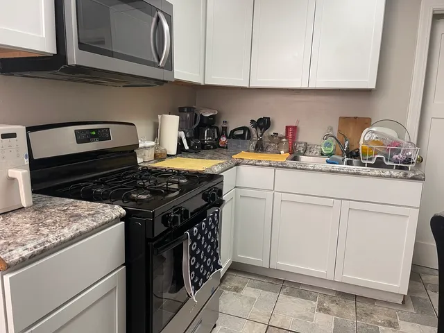 a view of a room that has a bed and mirror in it