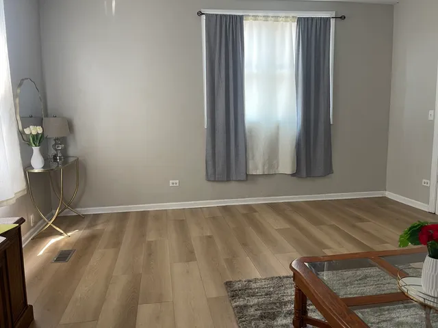 a view of a livingroom with wooden floor and flat screen tv