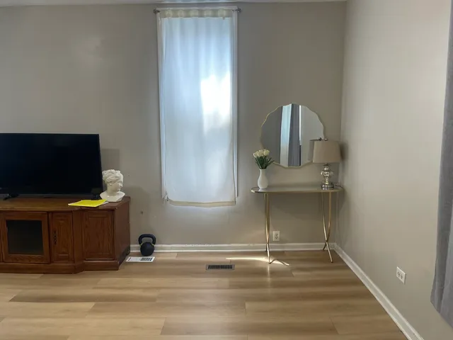 a dining room with furniture and wooden floor
