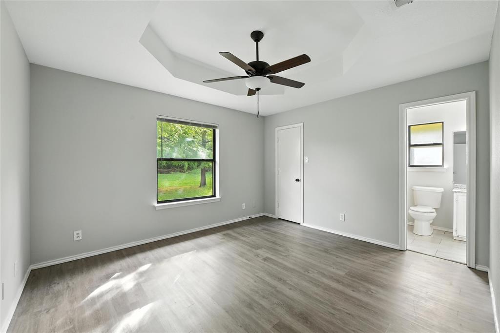 602 Valleyridge Court Decatur, TX 76234 - Photo 19 of 27 a view of an empty room with window and wooden floor