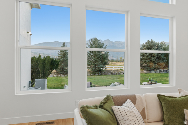 702 Alpine Highway Alpine, UT 84004 - Photo 27 of 83 Spacious living area featuring large windows, white trim, and wood-finish flooring