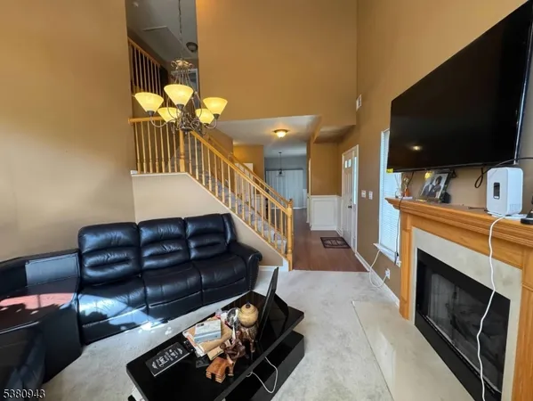 a living room with a fireplace and a flat screen tv