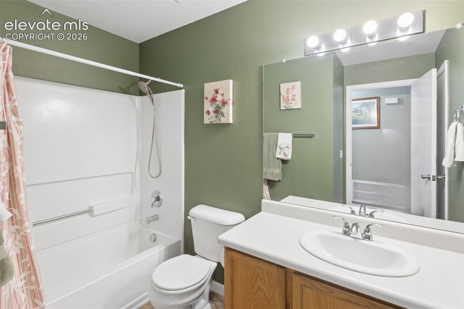9351 Bethpage Road Peyton, CO 80831 - Photo 19 of 32 Full bathroom featuring a single vanity with wood-finish cabinetry, a white countertop, and an integrated white sink
