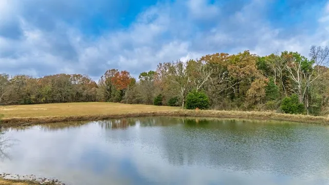 a view of a lake with houses in the back